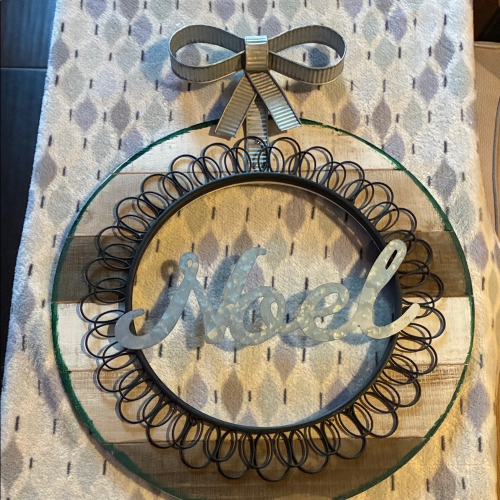 Metallic Noel Wreath with Bow. Wood around Sign